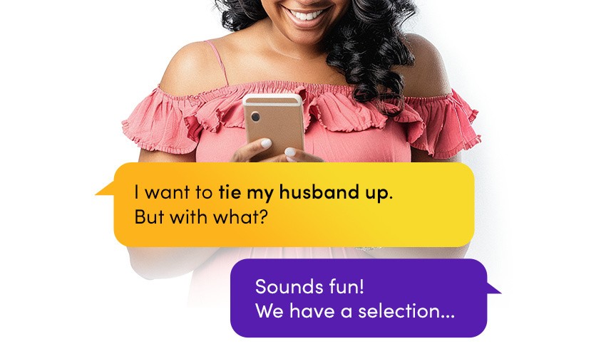 A woman in pink, feminine top asks the Lovehoney A.I.ssistant what she should tie her husband up with
